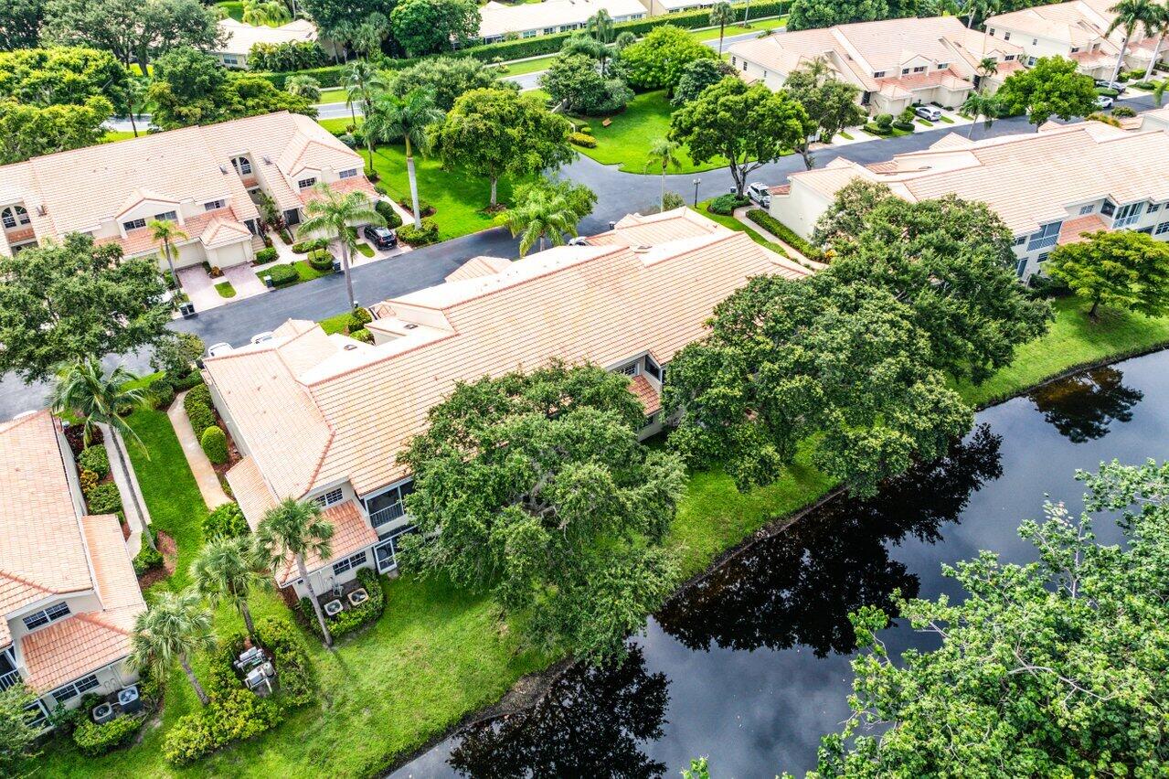 17266 Boca Club Boulevard, Unit 1603 Boca Raton, FL 33487 - Photo 38 of 42 an aerial view of a house with a yard and lake view