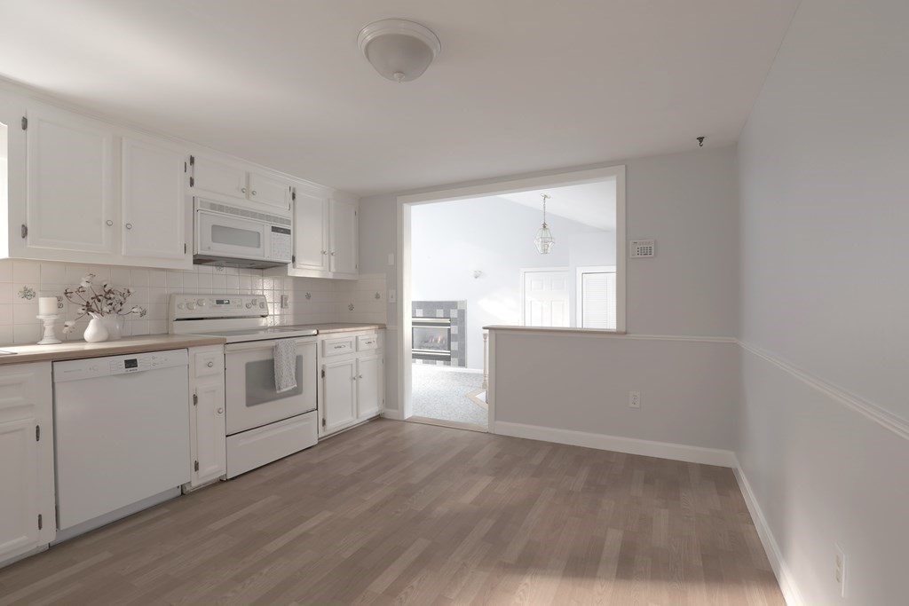 36 Parting Rock Road Duxbury, MA 02332 - Photo 15 of 29 a kitchen with white cabinets white appliances and sink