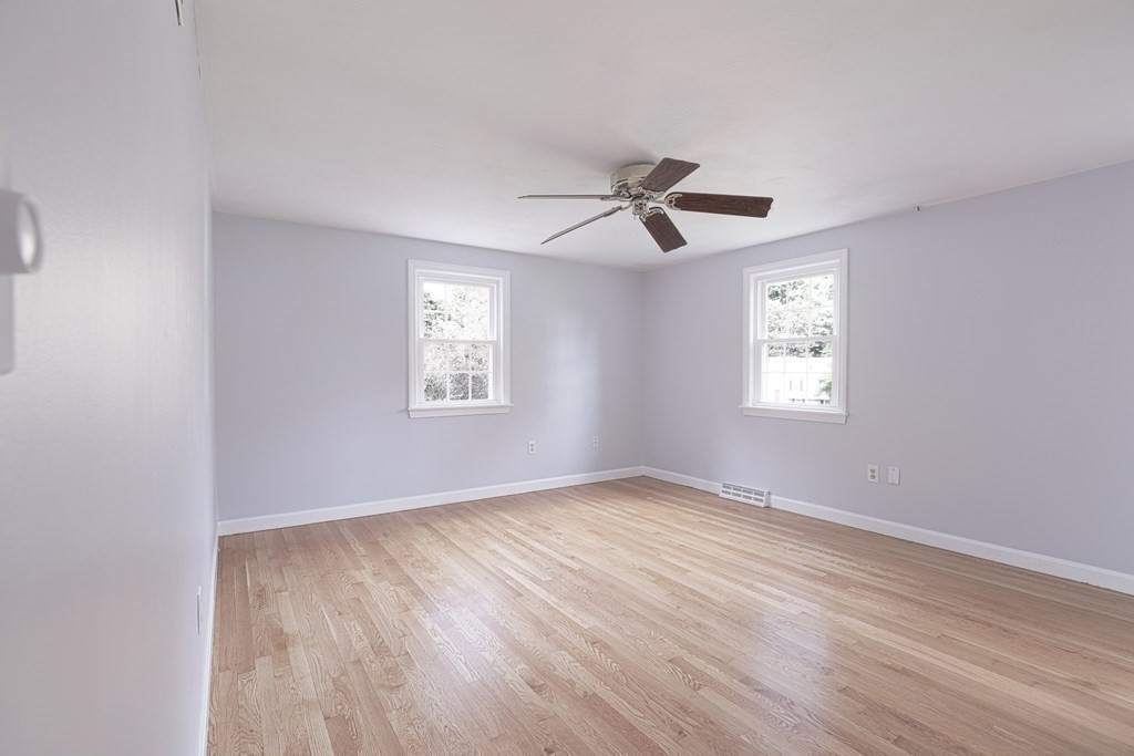 36 Parting Rock Road Duxbury, MA 02332 - Photo 20 of 29 a view of an empty room with a window and wooden floor