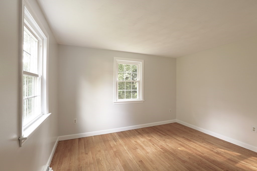 36 Parting Rock Road Duxbury, MA 02332 - Photo 21 of 29 an empty room with wooden floor and windows