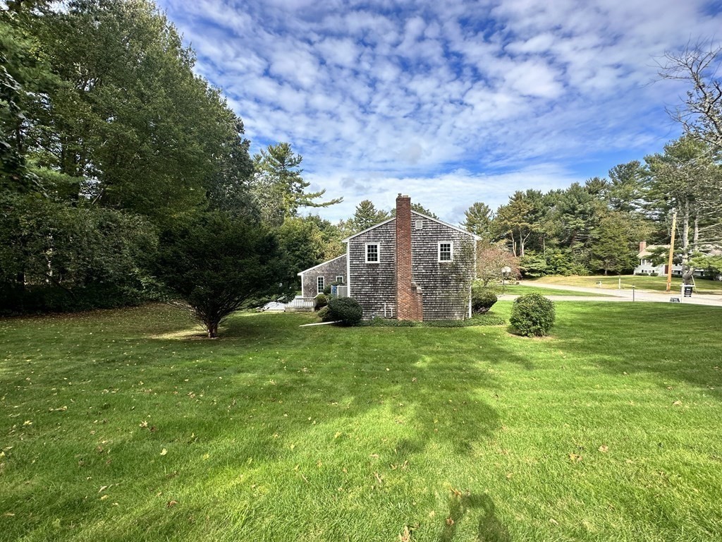 36 Parting Rock Road Duxbury, MA 02332 - Photo 28 of 29 a backyard of a house with plants and large trees