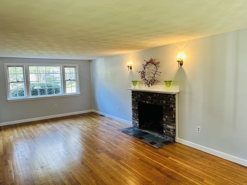 36 Parting Rock Road Duxbury, MA 02332 - Photo 9 of 29 a view of an empty room with a fireplace and a window