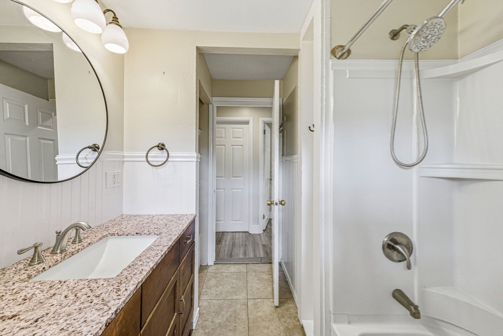 157 Errol Road Brockton, MA 02302 - Photo 31 of 34 a bathroom with a granite countertop sink a mirror a vanity and shower