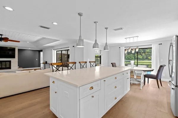 a large white kitchen with a large window