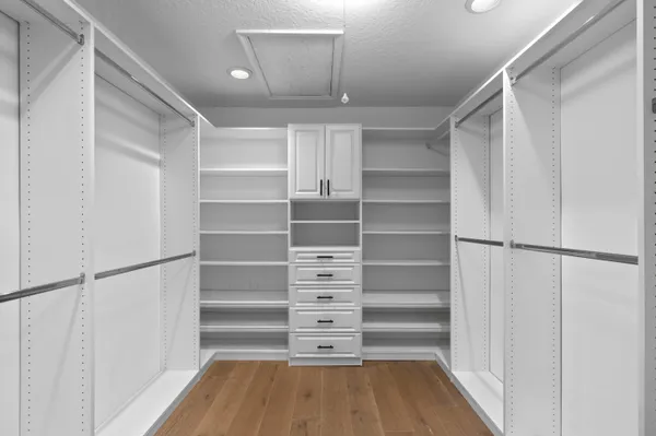 a view of walk in closet with empty racks
