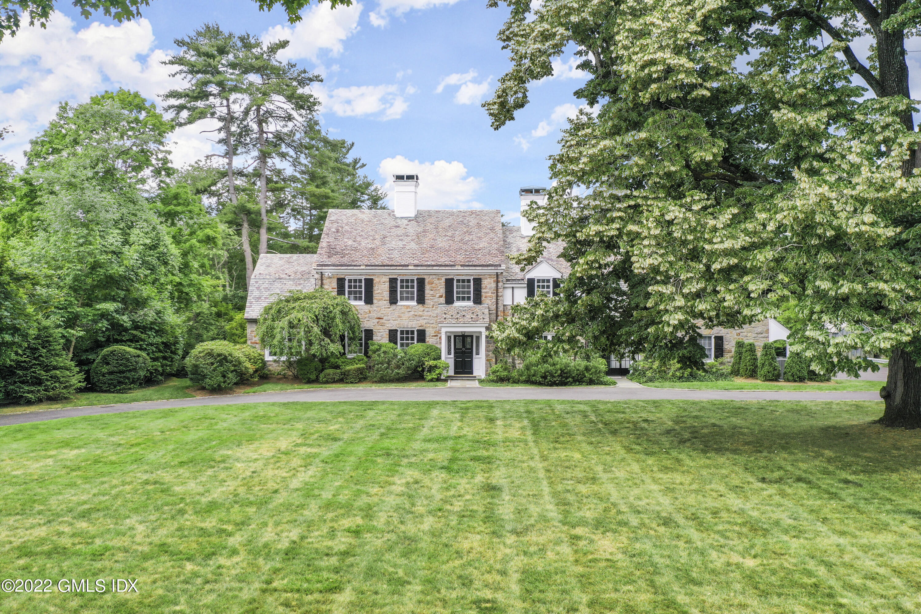 188 Stanwich Road Greenwich, CT 06830 - Photo 2 of 15 a front view of a house with a yard
