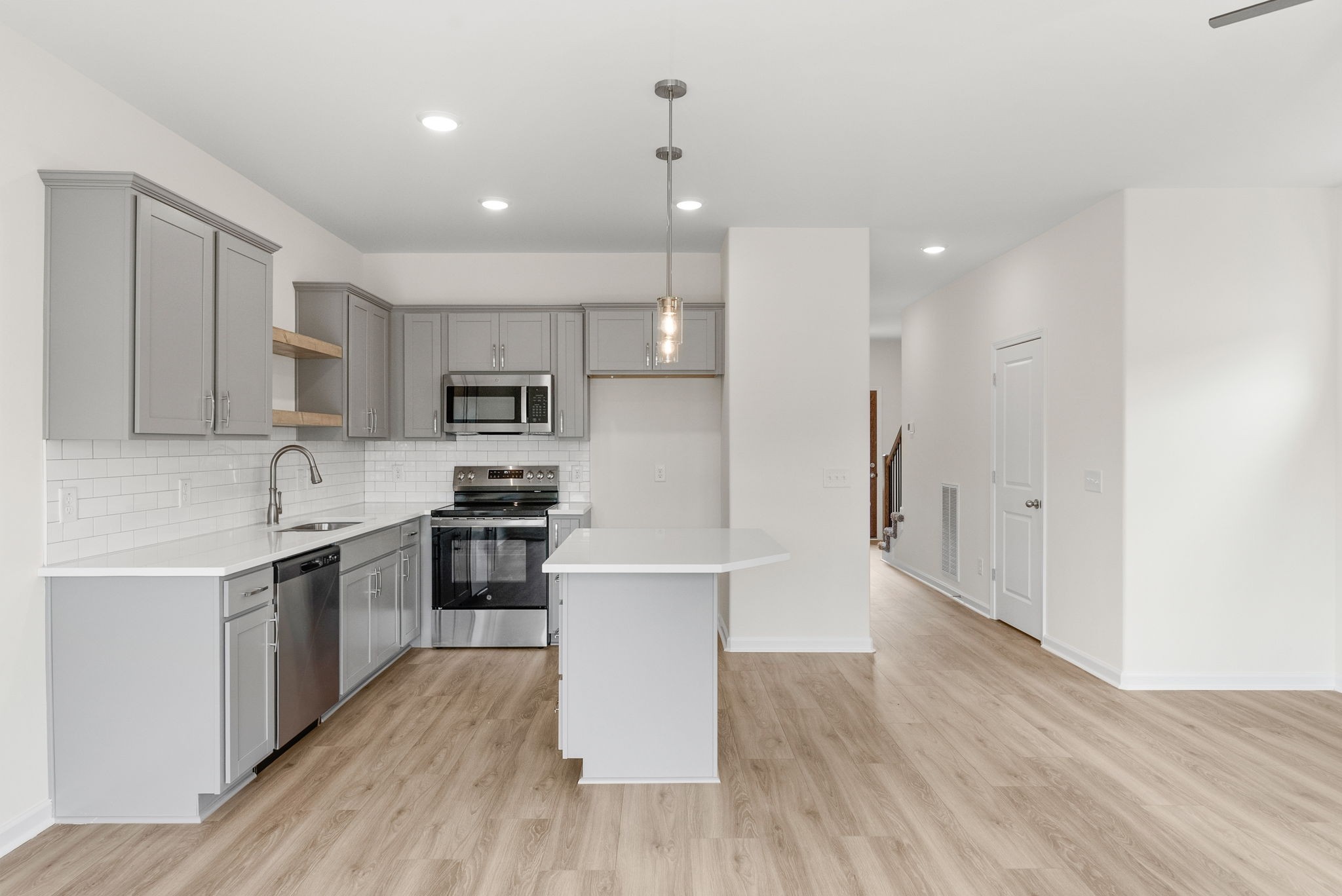 1912 Evans Road Clarksville, TN 37042 - Photo 2 of 32 a large kitchen with stainless steel appliances granite countertop a stove a sink dishwasher and a refrigerator with wooden floor