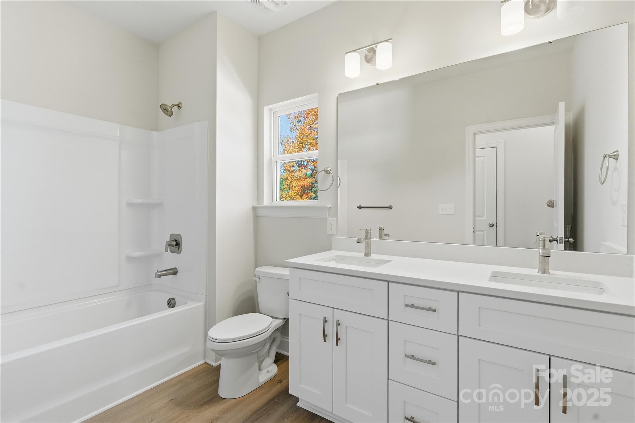 222 1st Street South Fort Mill, SC 29708 - Photo 15 of 23 a bathroom with a toilet a sink a tub and mirror
