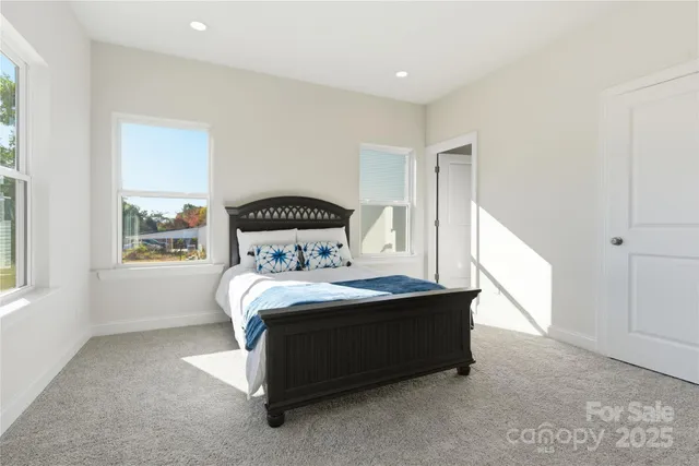 a bedroom with a bed and window