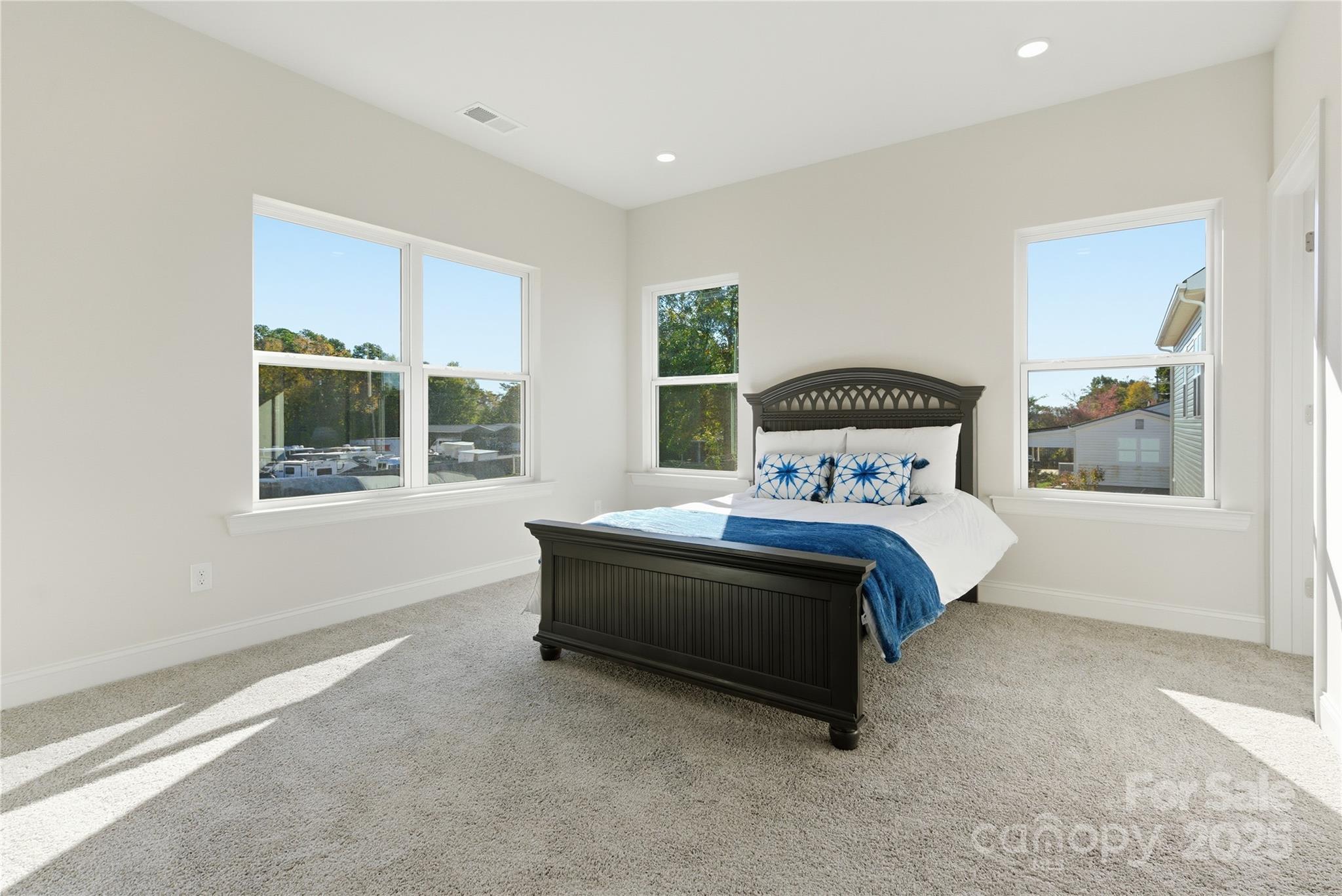 222 1st Street South Fort Mill, SC 29708 - Photo 18 of 23 a bed sitting in a spacious bedroom next to a window