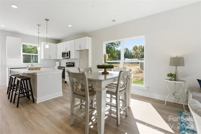 a view of a dining room with furniture window and wooden floor