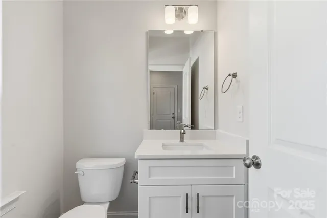a bathroom with a sink toilet and mirror
