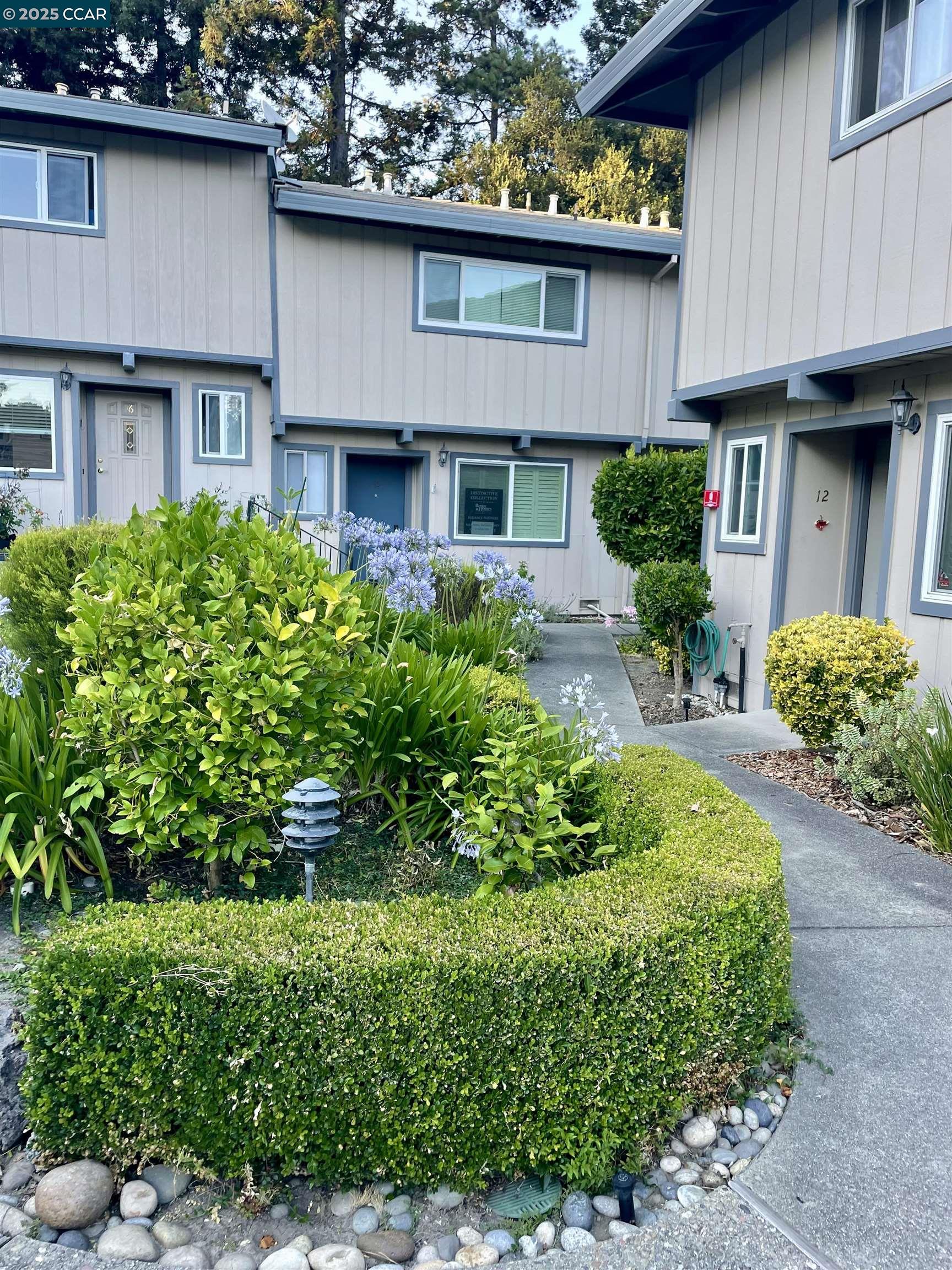 a front view of a house with a yard garage and outdoor seating