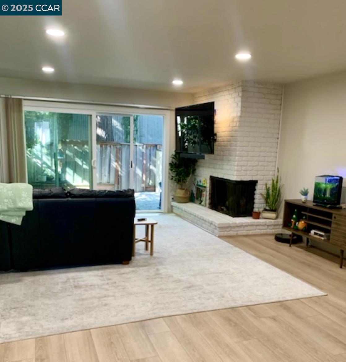 2129 Ascot Drive, Unit 15 Moraga, CA 94556 - Photo 2 of 9 a living room with fireplace furniture and a large window