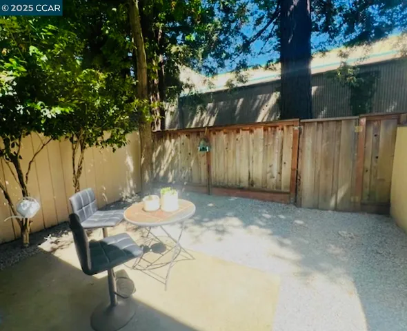 a backyard of a house with table and chairs