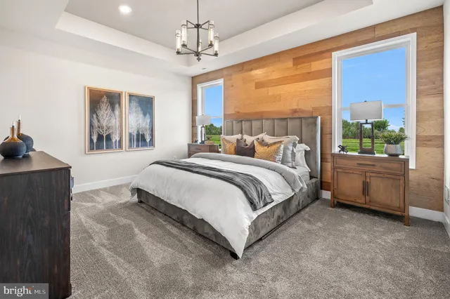 a spacious bedroom with a bed and a window