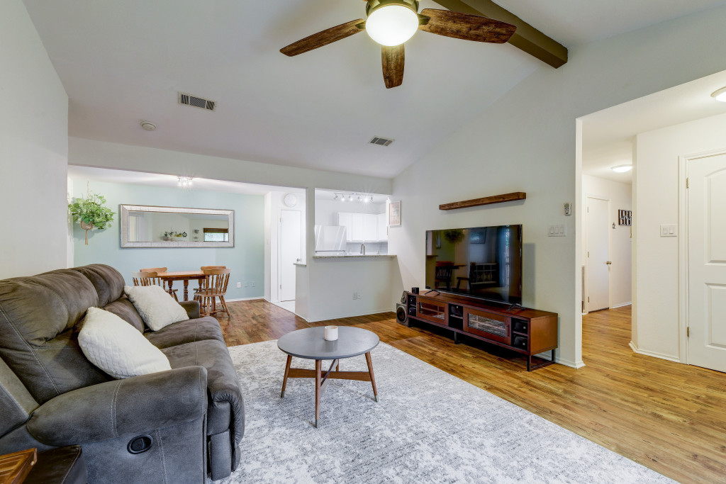 6002 Baton Rouge Drive Austin, TX 78727 - Photo 4 of 20 Spacious living area featuring vaulted ceilings with exposed wood beams and a ceiling fan
