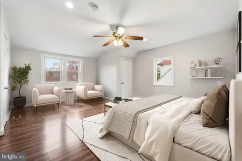 a bedroom with a bed couch and a window