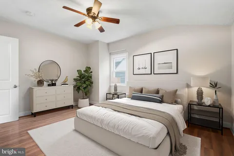 a bedroom with a large bed and a chandelier
