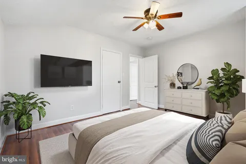 a bedroom with a bed and a television