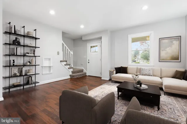 a living room with furniture and a book shelf