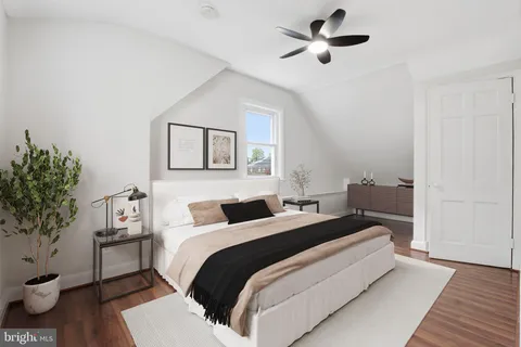 a bedroom with a bed and a potted plant