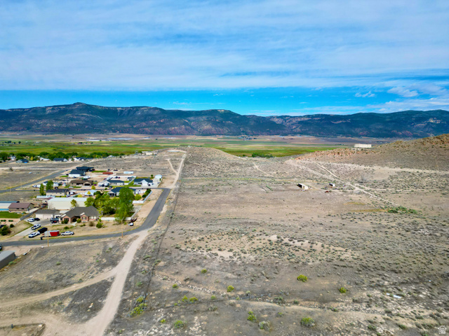 600 East E Street Moroni, UT 84646 - Photo 3 of 38 Expansive undeveloped land featuring natural desert vegetation, unpaved roads, and distant mountain ranges