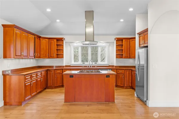 a kitchen with stainless steel appliances granite countertop a stove and a refrigerator