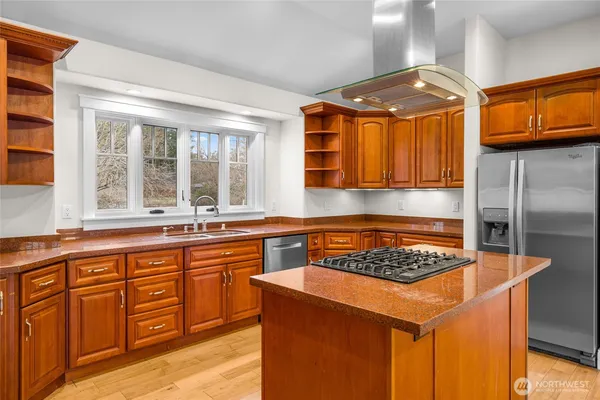 a kitchen with stainless steel appliances granite countertop a sink stove and cabinets