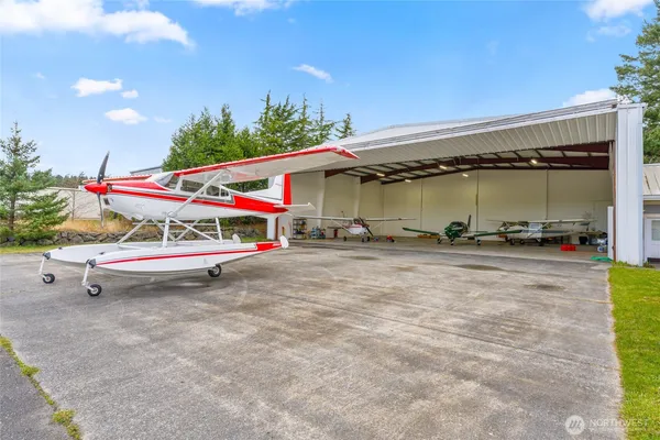 a view of a big yard with wooden fence