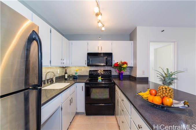 a kitchen with stainless steel appliances granite countertop a sink a stove and a refrigerator