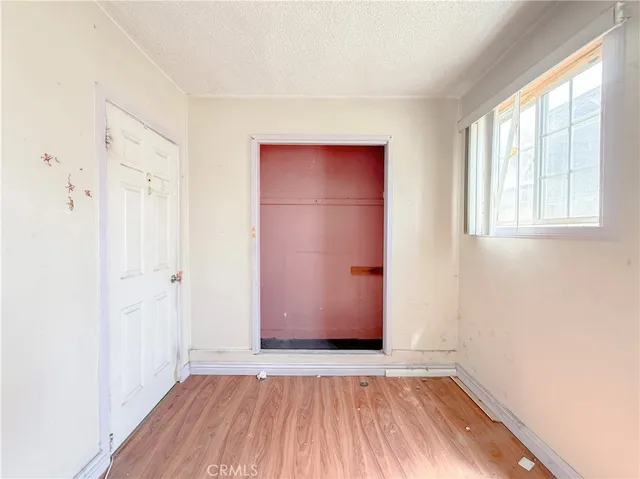 a view of a room with wooden floor and fan