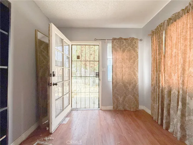 a view of entryway with wooden floor and door