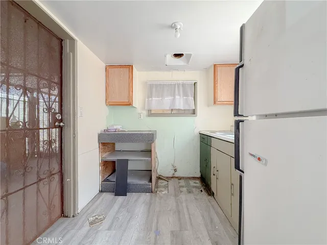 a view of a room with a wooden floor and a window