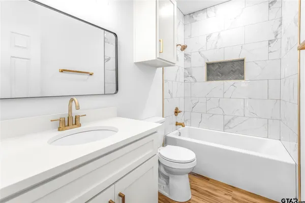 a bathroom with a sink a toilet and bathtub