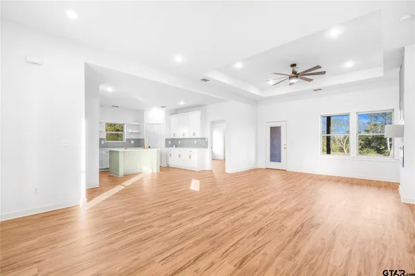 a view of kitchen with refrigerator and wooden floor