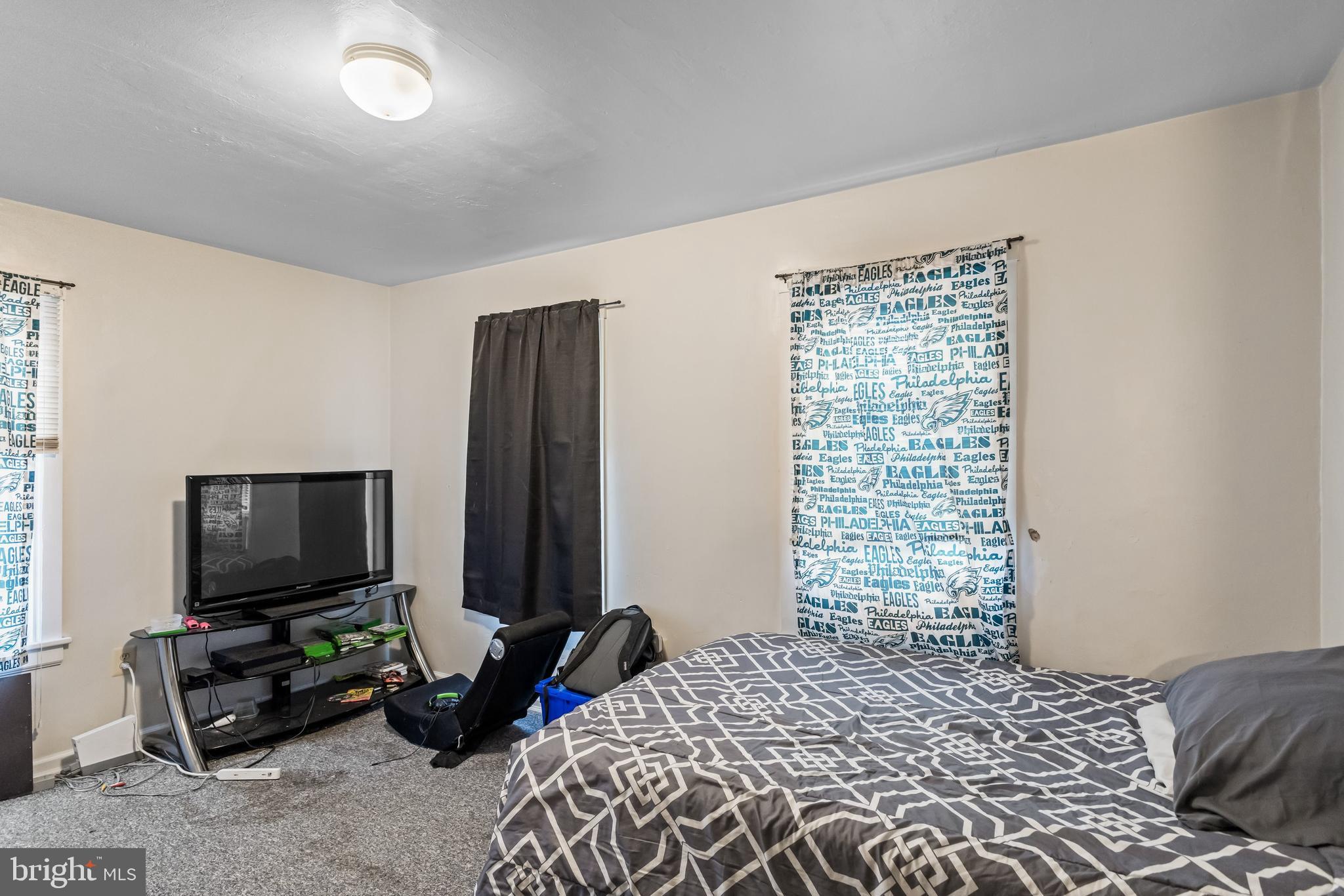 237 South 3rd Street Millville, NJ 08332 - Photo 16 of 23 a bedroom with a bed a television and a window