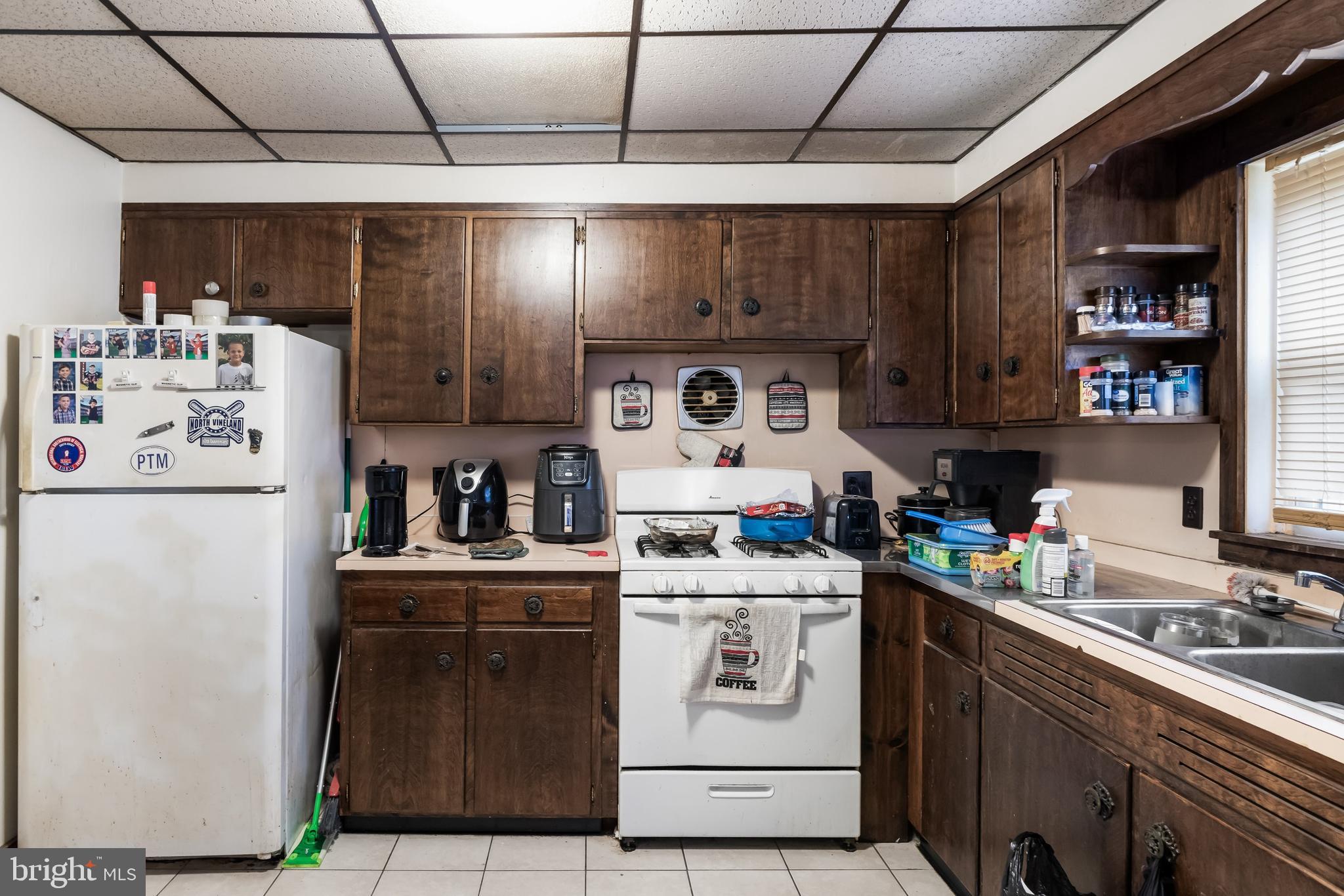 237 South 3rd Street Millville, NJ 08332 - Photo 9 of 23 a kitchen with a sink a stove and cabinets