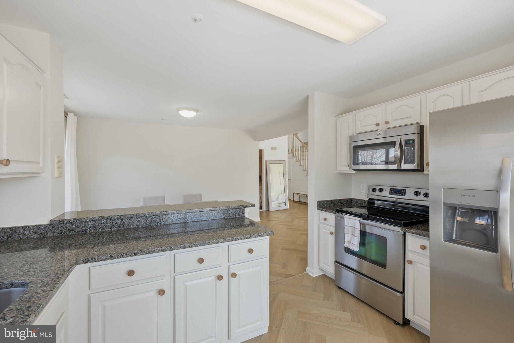 408 Ridgepoint Place, Unit 40838 Gaithersburg, MD 20878 - Photo 12 of 38 Modern kitchen with sleek finishes.