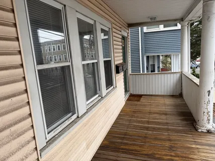 a view of a balcony with furniture
