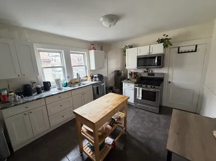 a kitchen with sink cabinets and appliances