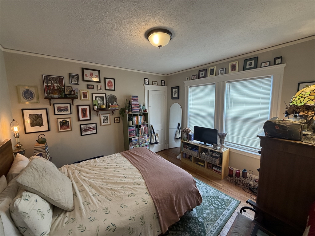 33-35 Sewall Street Somerville, MA 02145 - Photo 7 of 15 a bedroom with a bed and furniture