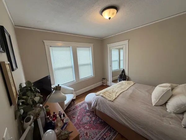 a bedroom with furniture and a window