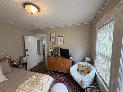 a bedroom with furniture and a window