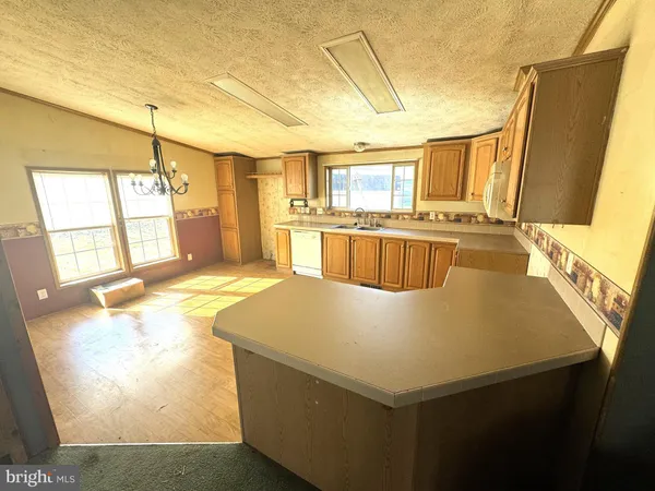 a large white kitchen with a large window