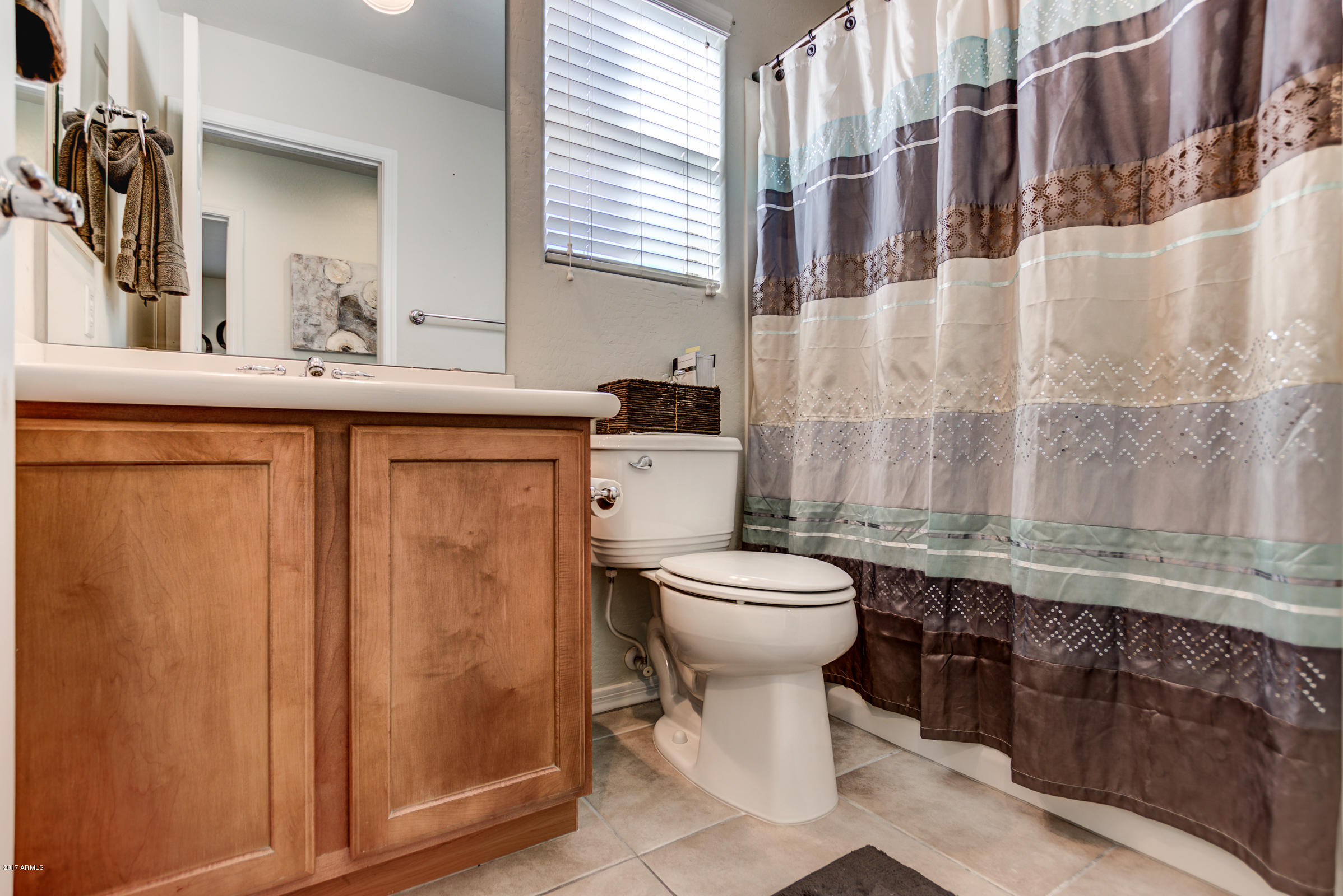 1935 West Davis Road Phoenix, AZ 85023 - Photo 20 of 30 a bathroom with a sink a toilet and a mirror