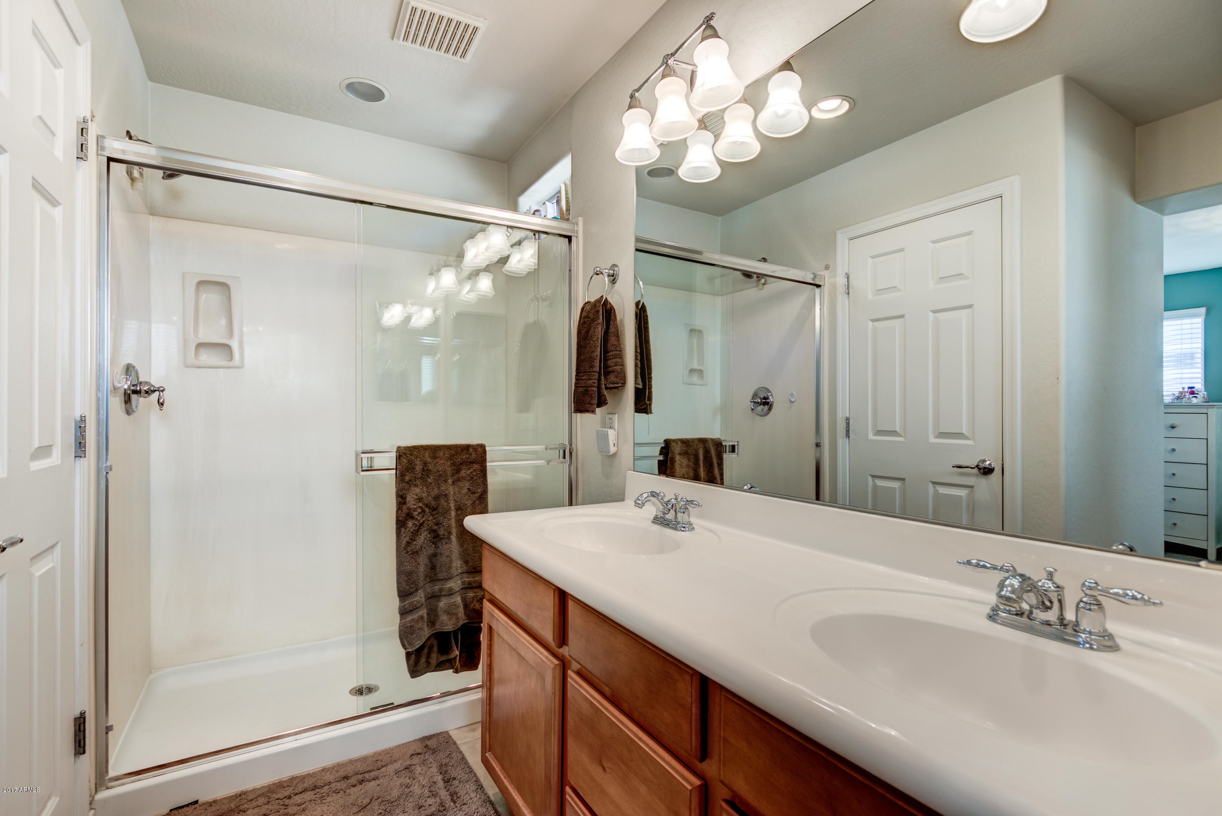 1935 West Davis Road Phoenix, AZ 85023 - Photo 24 of 30 a bathroom with a double vanity sink mirror and shower