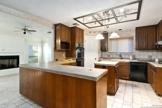 a kitchen with a sink appliances and cabinets