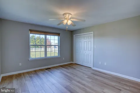 a view of wooden floor and windows in a room