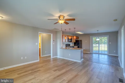 a kitchen with stainless steel appliances granite countertop a stove cabinets and wooden floor